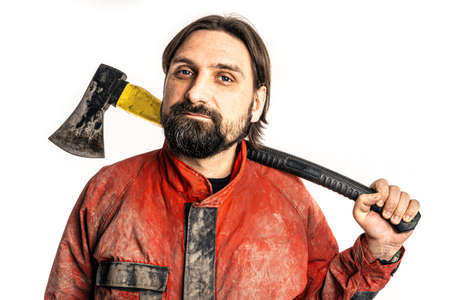 The man poses with an ax in a photo studio.の写真素材