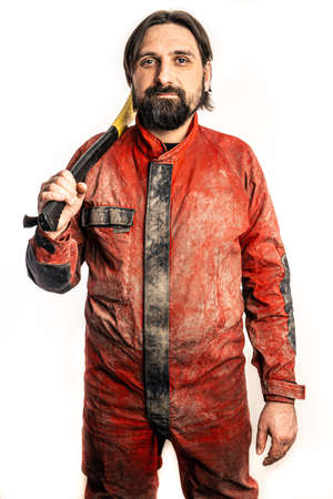 The man poses with an ax in a photo studio.の写真素材