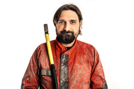 The man poses with an ax in a photo studio.の写真素材