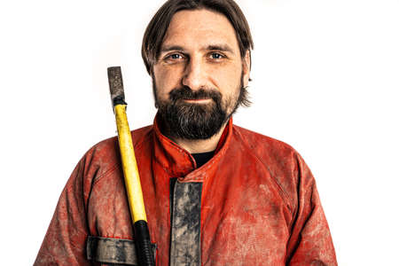 The man poses with an ax in a photo studio.の写真素材