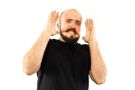 The man poses in a photo studio.