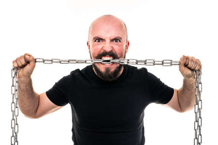 The man dressed in a black shirt poses in a photo studio.の写真素材
