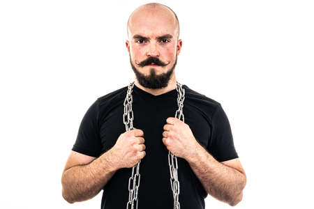 The man dressed in a black shirt poses in a photo studio.