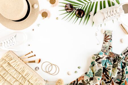 Female, summer street style. Womens frame of accessories. Dress, straw hat, bag, sunglasses and pineapple. Top view, flat lay.の写真素材