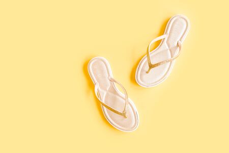 Womens summer traveler accessories sandals on yellow background. The concept of travel.の写真素材