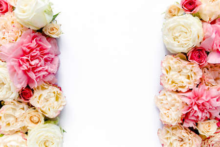 The workspace of pink and beige roses buds isolated on white wooden background. The apartment lay,...