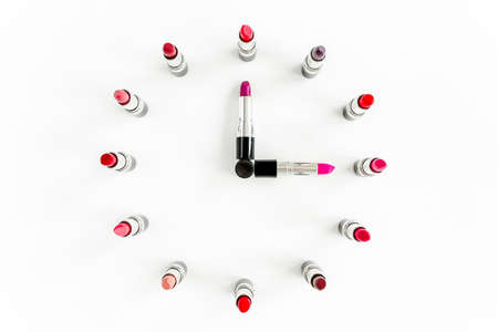 Set of color lipsticks in the form of hours on white background. Professional decorative cosmetics, pomade. beauty, fashion. flat lay, top viewの写真素材