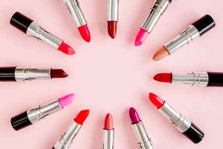 Set of color lipsticks on pink background. Professional decorative cosmetics, product pomade. Flat composition beauty, fashion. flat lay, top viewの写真素材