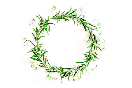 Round wreath frame made herbs, green branches, leaves rosemary. Flat lay. Top view.の写真素材