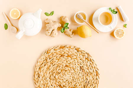 Herbal tea with mint, ginger, lemon, honey and other herbs on yellow background. Flat lay, top view.の写真素材