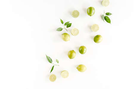Pattern made of lime and leaves ficus. Food concept. flat lay, top viewの写真素材
