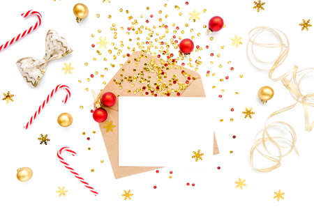 Styled desk with envelope, blank card and Christmas decorations. Flat lay. Mockup template. View...