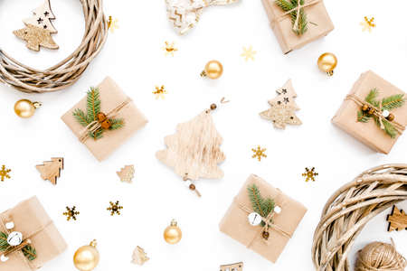 Christmas pattern made in gold colors and craft boxes on white background with empty. Holiday and...