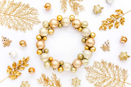 Holiday round frame, pattern made and gold glass Christmas balls, golden leaves isolated on a white background. Merry Christmas. Flat lay, top viewの写真素材