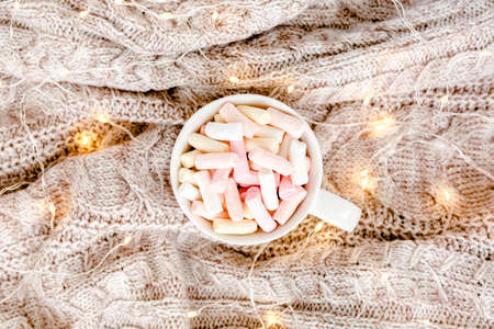 Cup of coffee wrapped in warm plaid. Autumn or Winter concept. Flat lay, top viewの写真素材