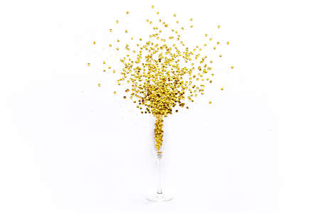 Champagne glasses with golden confetti tinsel on white background. Flat lay, top view celebrate party concept.の写真素材
