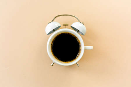 Coffee time, clock on yellow background. Flat lay, top viewの写真素材