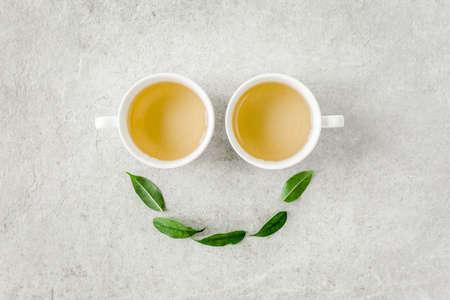 Cup of fresh green tea with tea leaves. Flat lay, top view. Tea conceptの写真素材