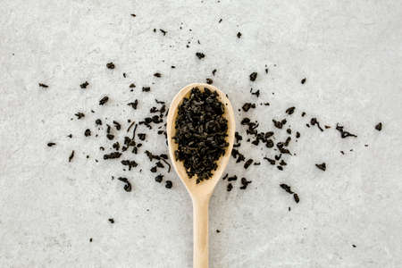 Dry tea leaves on gray background. Flat layの写真素材