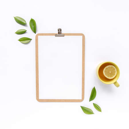 Clipboard mock up with frame green leaves isolated on white background. Flat lay, top view....