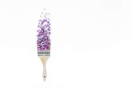 Flowers and brush with purple lilac isolated on white background. Flat lay, top viewの写真素材