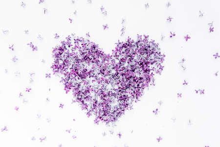 Heart symbol made of purple lilac. Valentines day background. Flat lay, top viewの写真素材