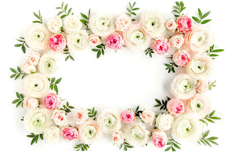 Floral pattern frame made of pink ranunculus and roses flower buds on white background. Flat lay,...