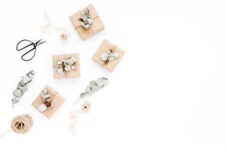 Christmas pattern, texture made in of craft boxes and green branches in the snow. Holiday and...
