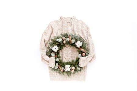 Woman sweater and Christmas a wreath from fir, pine and spruce twigs isolated on white background....