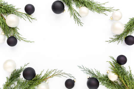 Christmas or new year frame composition. Christmas golden and black balls and fir branches on white background. Holiday. Top view. Flat layの写真素材