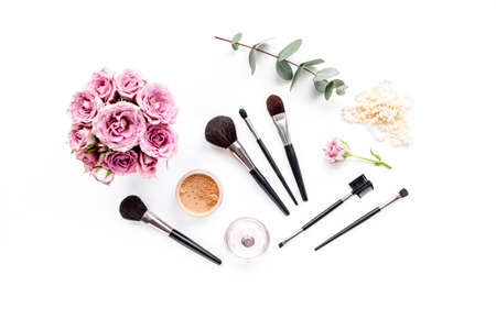 Makeup tools. Home office workspace. Female fashion, makeup brushes, cup of coffee on white background. Flat composition. Top view. Flat lay.の写真素材