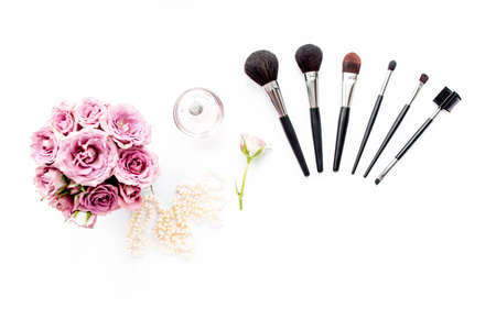 Makeup tools. Home office workspace. Female fashion, makeup brushes, cup of coffee on white background. Flat composition. Top view. Flat lay.の写真素材
