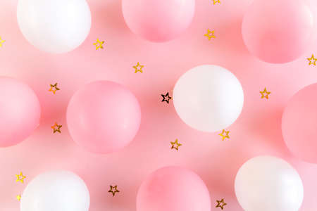 Balloons and confetti on pink background. Valentines day, Birthday, holiday concept. Flat lay, top viewの写真素材