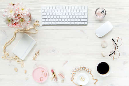 Top view office desk. Workspace with, computer, chrysanthemum, clipboard. Womens fashion accessories...