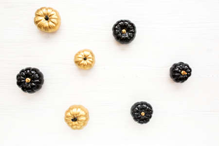 Stylish Halloween decorations. Decorative pumpkin black and gold Halloween isolated on white background. Flat lay, top view.の写真素材