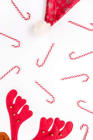 Christmas or new year pattern, texture made of Christmas candies, deer hat on white background. Holiday and celebration concept. Flat lay, top view.の写真素材
