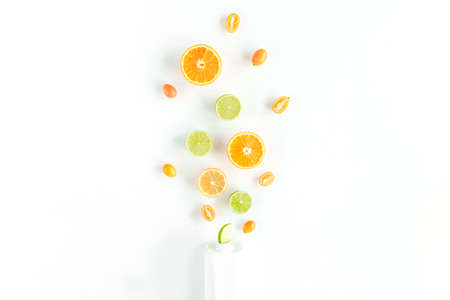 Creative pattern made of summer tropical fruits: orange, lemon, lime. Food concept. flat lay, top viewの写真素材