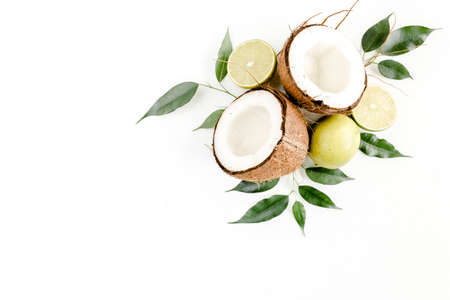 Creative pattern made of summer tropical fruits: coconut, lime and leaves ficus. Food concept. flat lay, top viewの写真素材