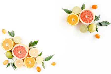 Creative layout made of summer tropical fruits: grapefruit, orange, lemon, lime and leaves ficus. Food concept. flat lay, top viewの写真素材
