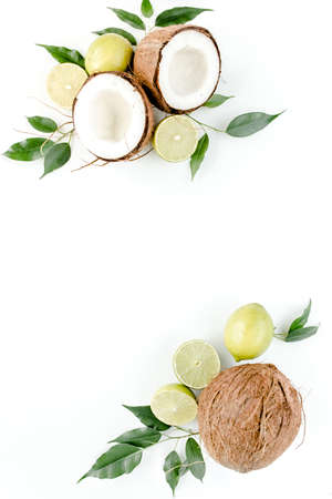 Creative pattern made of summer tropical fruits: coconut, lime and leaves ficus. Food concept. flat lay, top viewの写真素材
