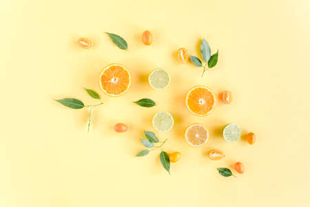 Creative background made of summer tropical fruits: grapefruit, orange, lemon, lime and leaves ficus. Food concept. flat lay, top viewの写真素材