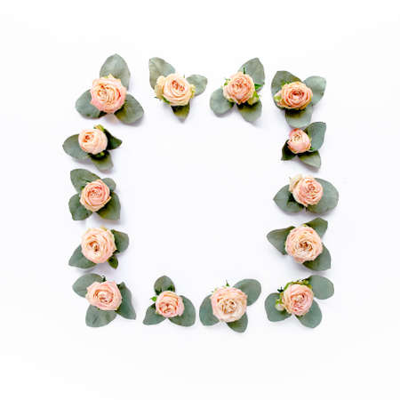 frame made of pink roses, green leaves eucalyptus, branches, floral pattern on white background. Flat lay, top view. Valentines background.の写真素材