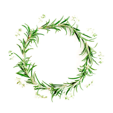 Round wreath frame made herbs, green branches, leaves rosemary. Flat lay. Top view.の写真素材