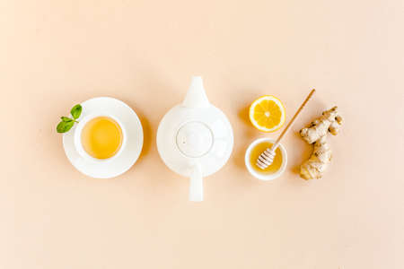 Herbal tea with mint, ginger, lemon, honey and other herbs on yellow background. Flat lay, top view.の写真素材