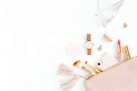 Flat lay composition with pink cosmetic bag with cosmetic makeup products, isolated on white background. Flat lay, top view.の写真素材