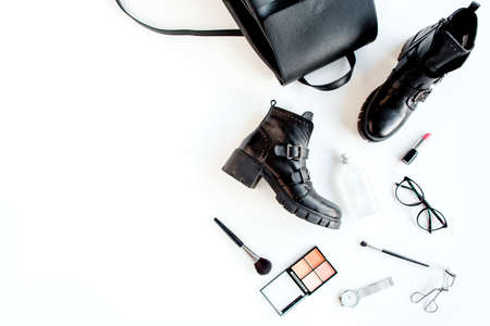 Women fashion accessories on white background top view. Flat lay female style look with Black backpack and bots. Top view.の写真素材