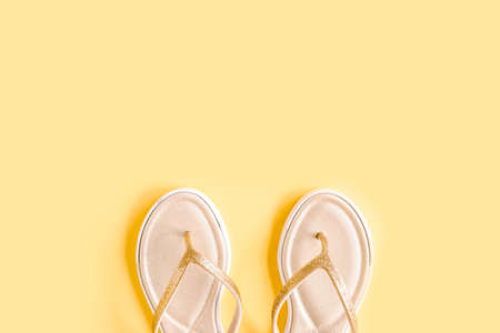 Womens summer traveler accessories sandals on yellow background. The concept of travel.の写真素材