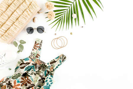 Female, summer street style. Sundress-dress, straw hat, sneakers, sunglasses and tropical leaf. Top view, flat lay.の写真素材