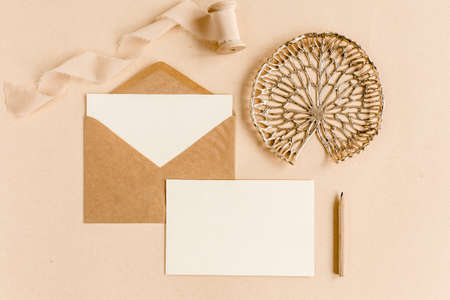 Mockup wedding invitation, blank greeting card and craft envelope. Flat lay, top view.の写真素材