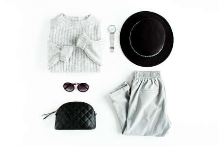 Women fashion clothes and accessories. Feminine youth collage top view. Flat lay female style look with warm sweater, jeans, glasses. Top view.の写真素材